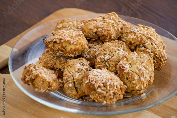 Obraz Homemade oatmeal cookies with coconut chips, muesli, dried apricots and other delicacies. Sweet and healthy snack,