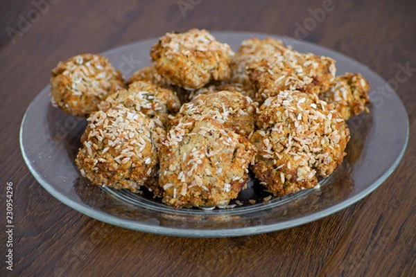 Fototapeta Homemade oatmeal cookies with coconut chips, muesli, dried apricots and other delicacies. Sweet and healthy snack,