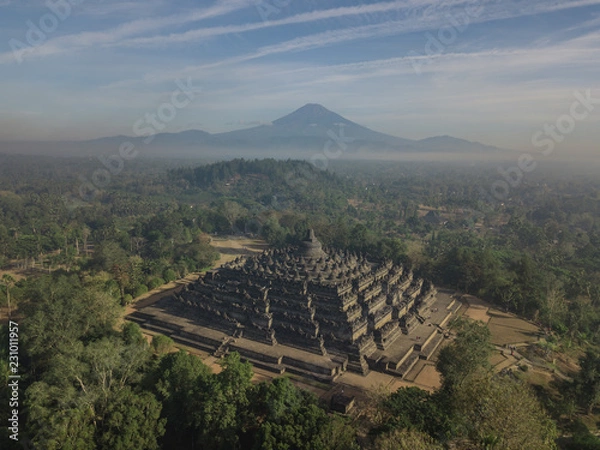 Fototapeta Misty morning of Borobudur ancient temple and Mount Merapi in East Java, Indonesia