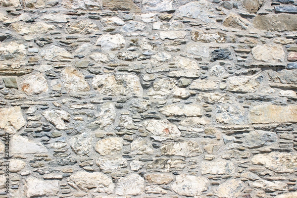 Fototapeta Stone brick wall uneven surface texture background