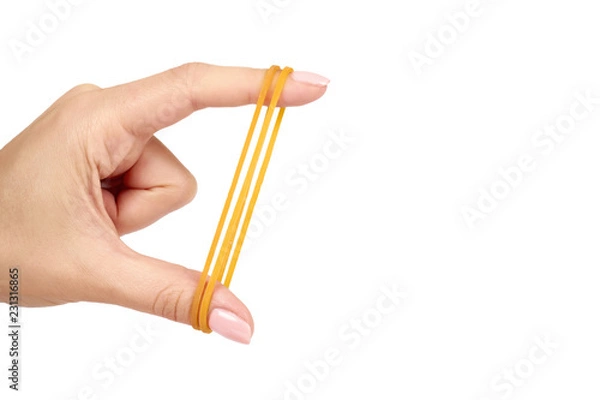 Obraz Yellow rubber bands close up with hand isolated on white background, copy space template.