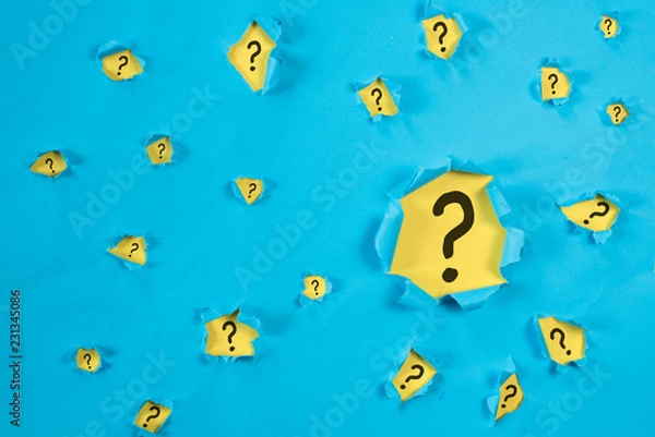 Fototapeta Torn blue paper revealing QUESTION MARK on yellow paper. concept of questions, faq, q&a, problem, riddle and quiz background