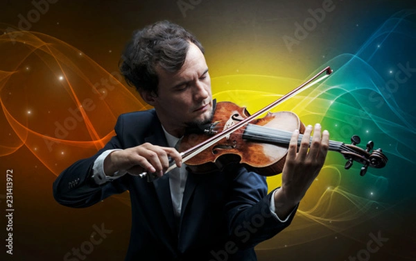 Fototapeta Serious classical violinist with fabled sparkling wallpaper