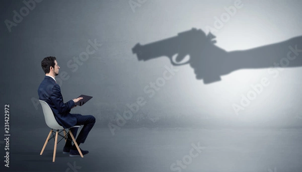 Fototapeta Small businessman staying and offering stuffs for an armed shadow hand

