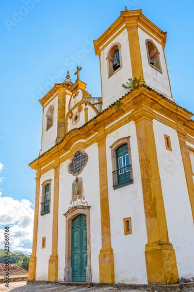 Fototapeta Facade of the church of Church of Our Lady of Mercy and Mercy in Ouro Preto, Minas Gerais with its windows, large wooden door, stone arch and baroque sculptures