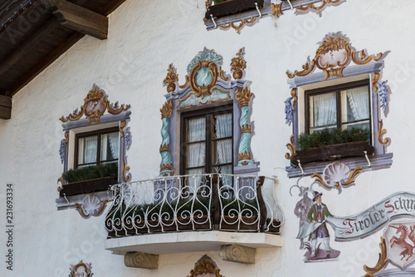 Fototapeta Traditional ornamented painted facade and balcony of Tyrolean building in Seefeld