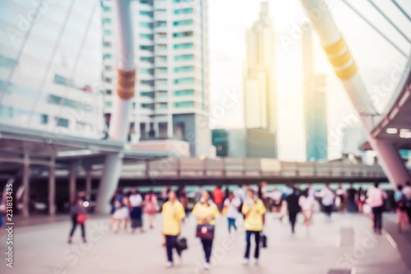 Fototapeta Blurred background. Blurred people walking through a city street on sunset of an urban landscape