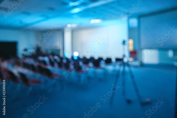 Fototapeta conference lecture theatre cinema hall or seminar room background with projection light theatre blur
