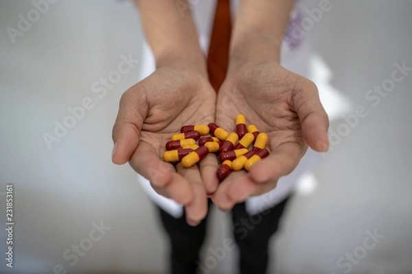 Fototapeta Hand of doctors holding many  pills