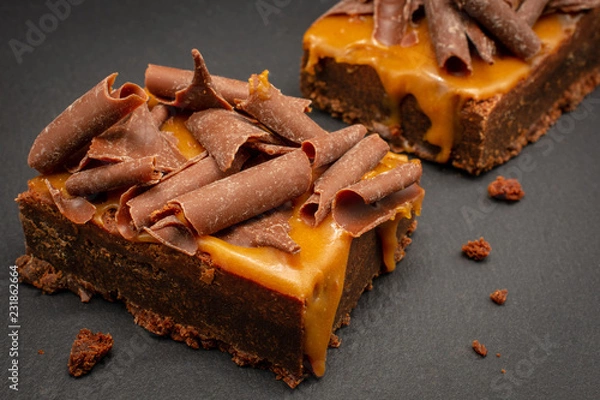 Fototapeta Chocolate Brownies with salted caramel sauce and chocolate flakes