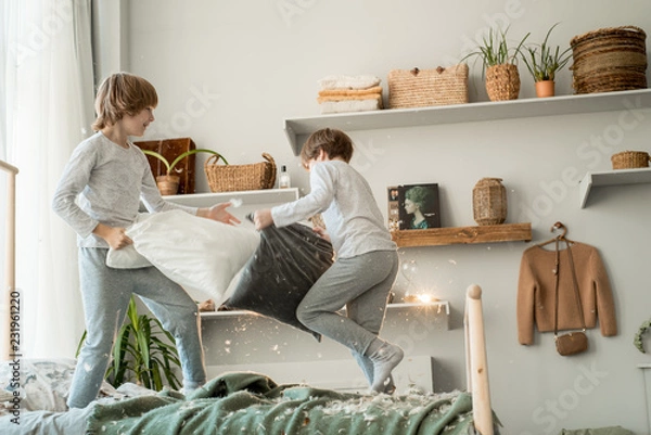 Obraz Small boys having pillow fight, doing mess in room