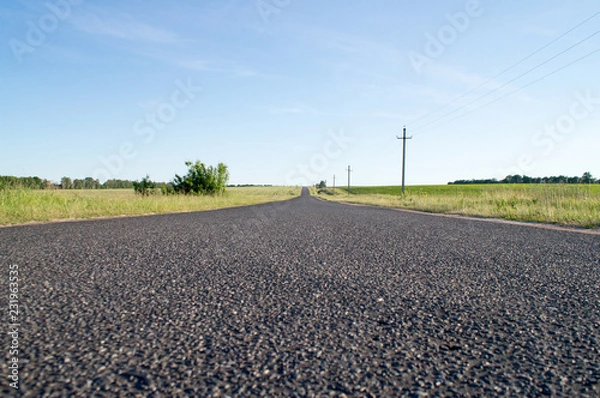Obraz The empty asphalted road going to the blue sky