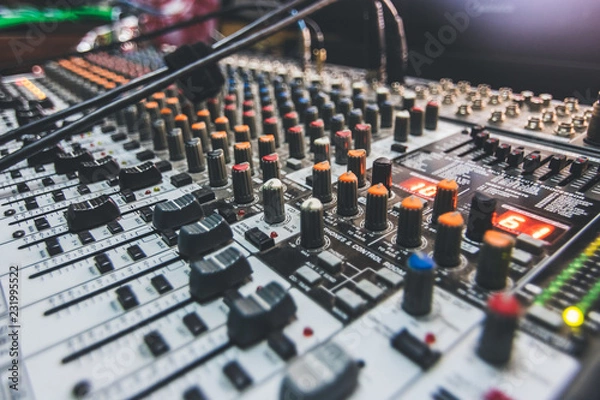 Fototapeta A mixing board up close on the knobs and levers