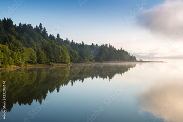 Fototapeta Morning view on foggy Shaori Lake at sunrise Georgia country