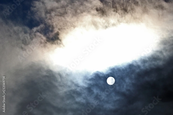 Fototapeta solar disk at noon through the clouds