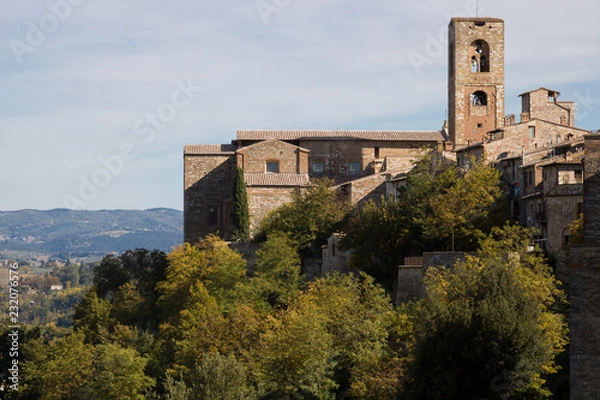 Fototapeta Medieval hamlet. Landscape with medieval hamlet on the hill, with Church and its bell tower