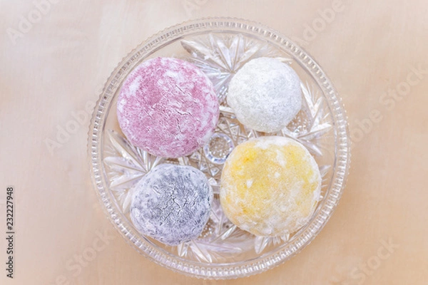 Obraz Four round whole mochi sticky glutinous rice cake dessert pieces, colorful multicolored natural food dye wagashi daifuku filled with ice cream