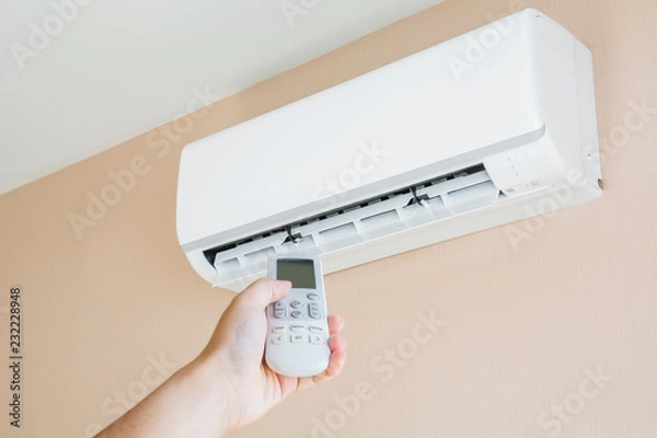 Fototapeta Hand controlling a remote control