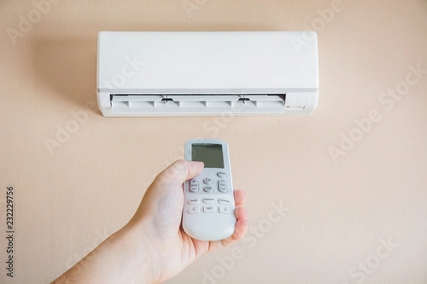 Obraz Hand controlling a remote control