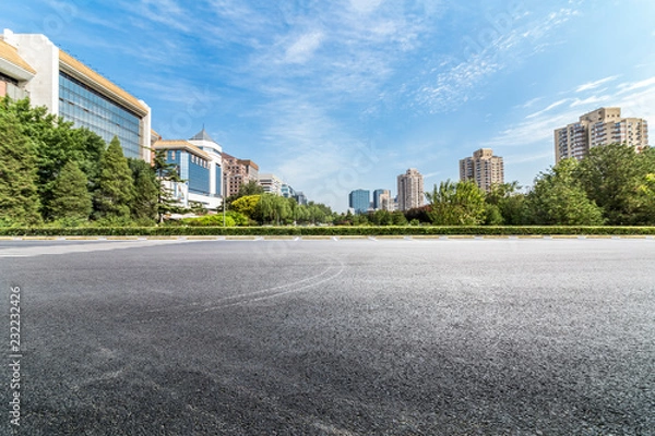 Fototapeta Panoramic skyline and modern business office buildings with empty road,empty concrete square floor