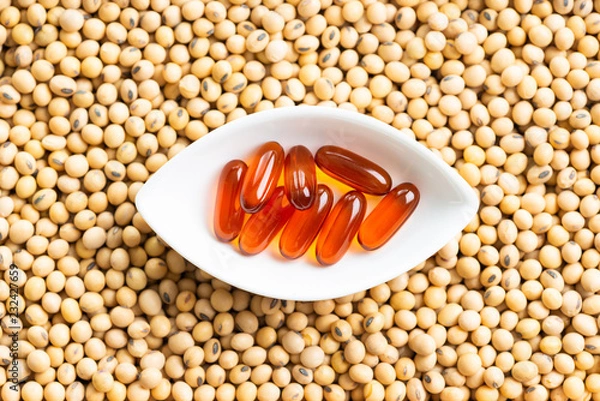 Fototapeta Lecithin gel pills capsule with soy background
