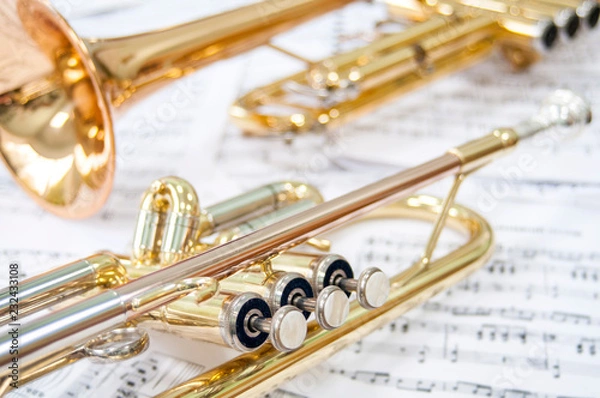 Fototapeta Still life. Two golden trumpets lie on notes. Brass duet.