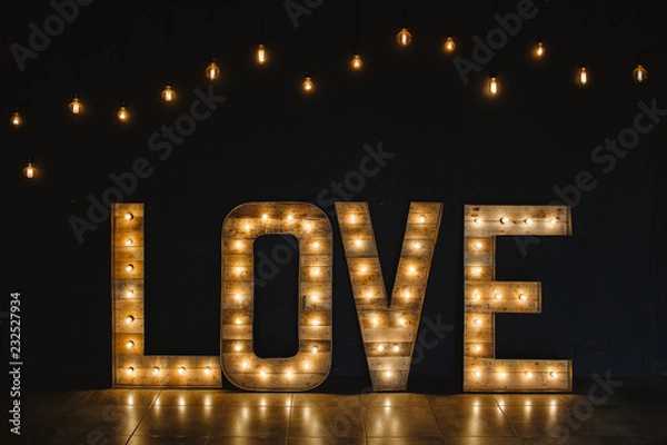 Obraz The word love wood with light.