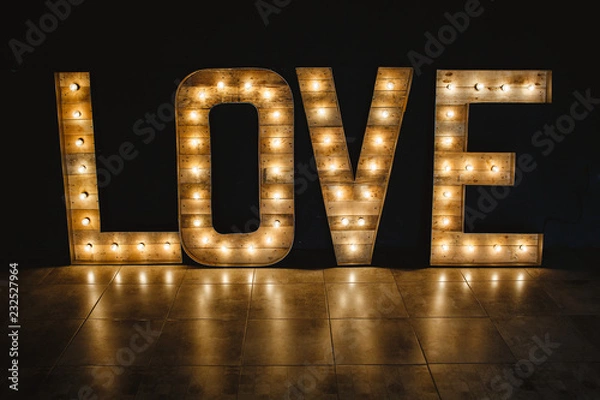 Obraz The word love wood with light.