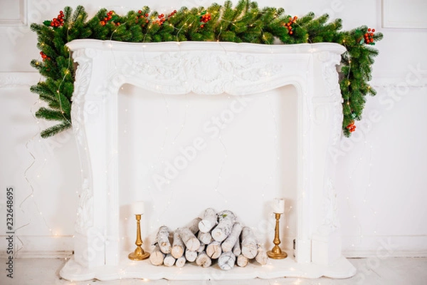 Fototapeta Beautiful Christmas room with decorateв, gifts on white fireplace. The idea for postcards. Place for text. Isolated