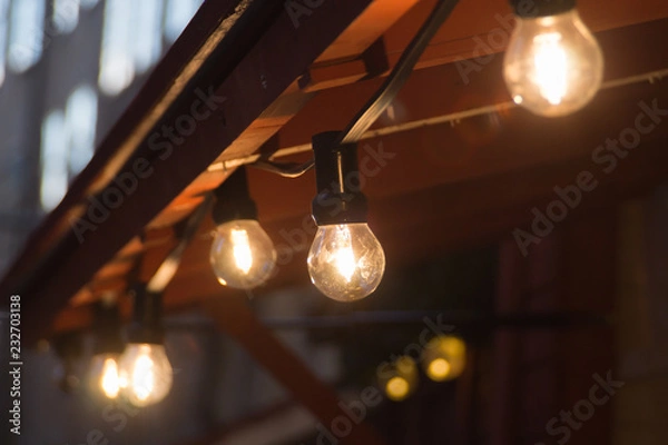 Fototapeta Glowing incandescent lamp with soft light background