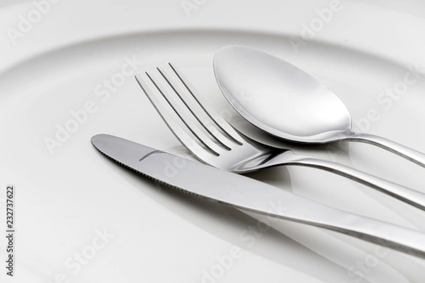Fototapeta Fork and spoon on an empty plate