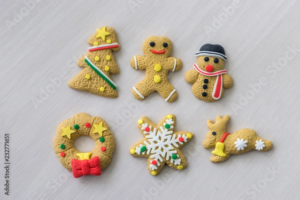 Fototapeta Colorful christmas cookies on wooden table as background