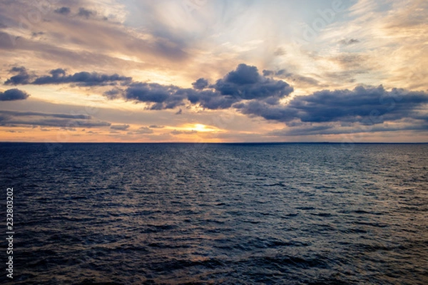 Obraz Travel by ferry in the Baltic Sea at sunrise with Sweden on the horizon. Taken from the Color Line Fantasy which is a cruise ferry between Kiel and Oslo. 