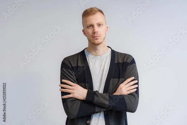 Fototapeta Studio portrait concept of a smiling young man talking on a white background.