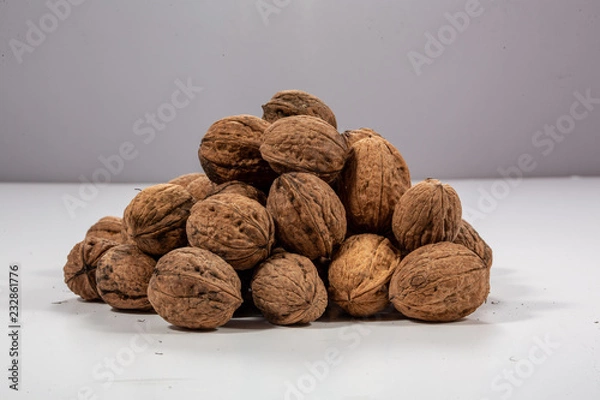 Fototapeta pile of walnuts on white background