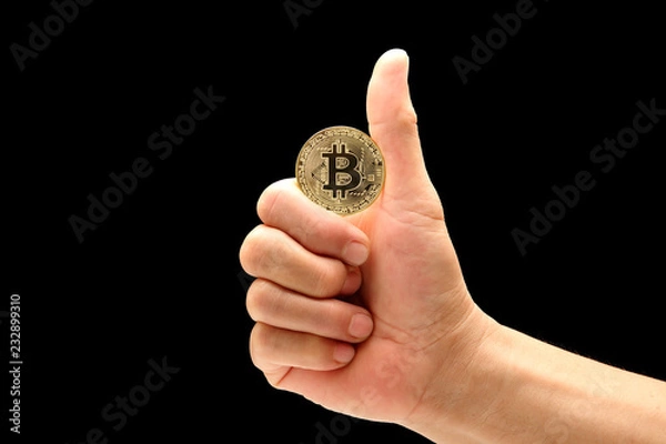 Fototapeta man hand in good symbol to holding bitcoin isolated on black background
