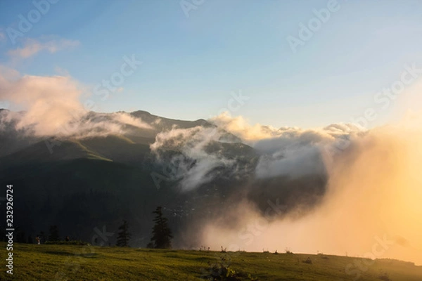 Fototapeta clouds before sunset in the mountains