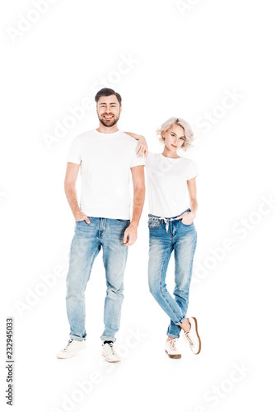 Fototapeta Wonderful smiling couple standing together while woman leaning to man isolated on white