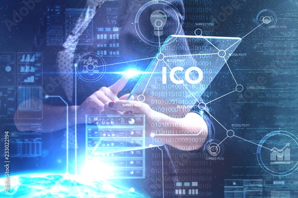 Fototapeta The concept of business, technology, the Internet and the network. A young entrepreneur working on a virtual screen of the future and sees the inscription: ICO