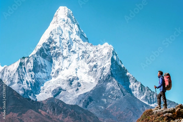Fototapeta Hiker with backpacks reaches the summit of mountain peak. Success, freedom and happiness, achievement in mountains. Active sport concept.