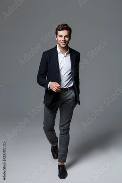 Fototapeta Full length portrait of a happy young businessman