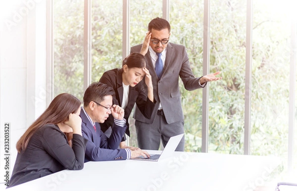 Obraz business concept; Stressed boss and executive team searching problem solution at meeting, partners holding heads in hands depressed by failure bad news, feeling desperate about company problem