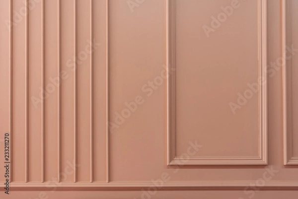 Fototapeta Composition of wood moulding in classic detail installed on pink painted wall / background image / texture