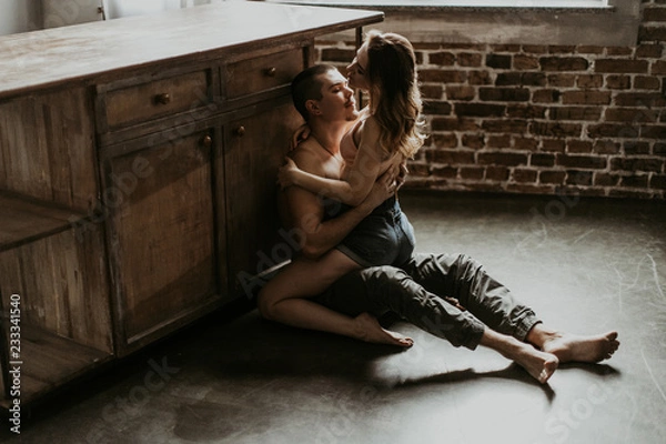 Obraz  beautiful loving couple kissing in the kitchen