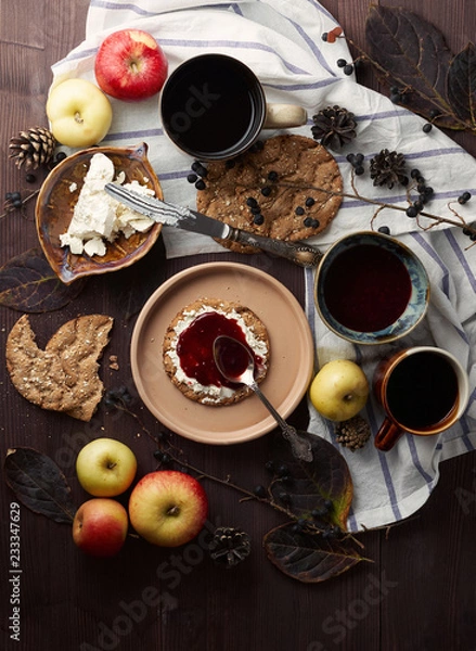 Fototapeta Swedish rye crispbread with cream cheese and raspberry jam. Autumn and winter breakfast concept.