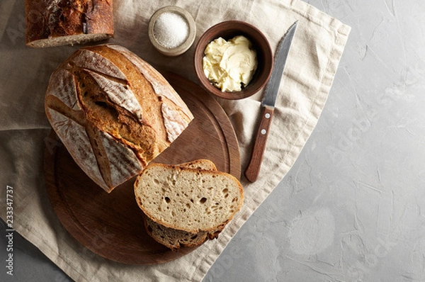 Fototapeta Artisan sliced toast bread with butter and sugar on wooden cutting board