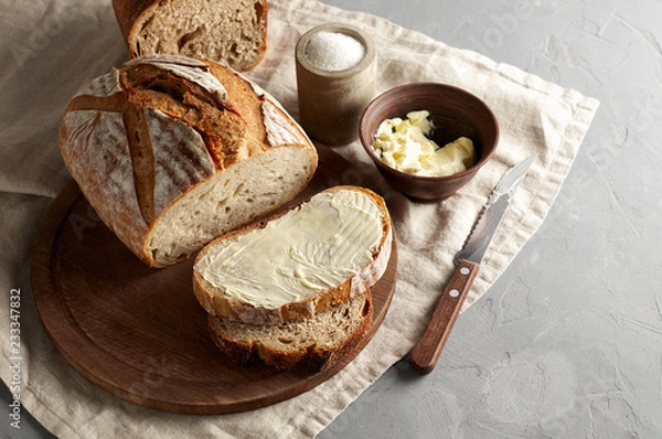 Fototapeta Artisan sliced toast bread with butter and sugar on wooden cutting board