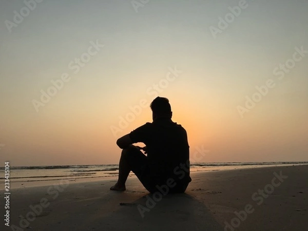 Obraz man on the beach enjoying sunset