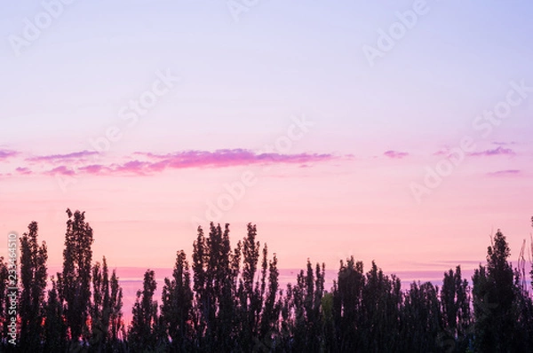 Fototapeta Landscape with dramatic light - beautiful golden sunset with saturated sky and clouds.