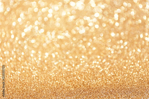Fototapeta Golden sparkle glitters with bokeh effect and selectieve focus. Festive background with bright gold lights, champagne bubble. Christmas mood concept. Copy space, close up, texture, top view.